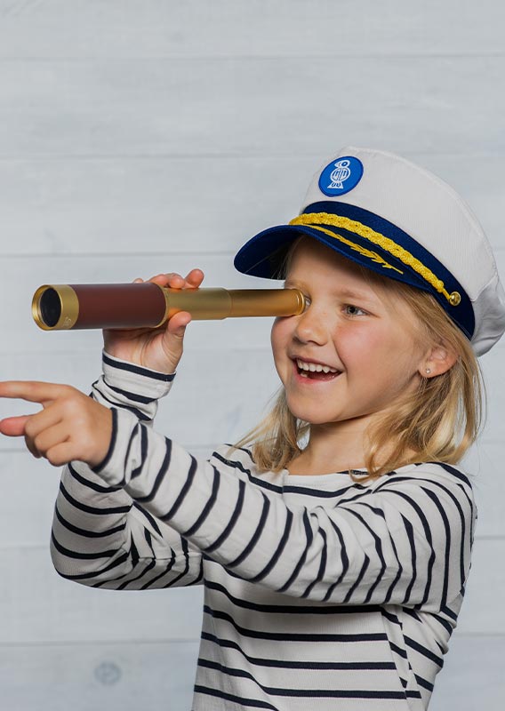 A child holds up a monoscope to look out at something out of view.