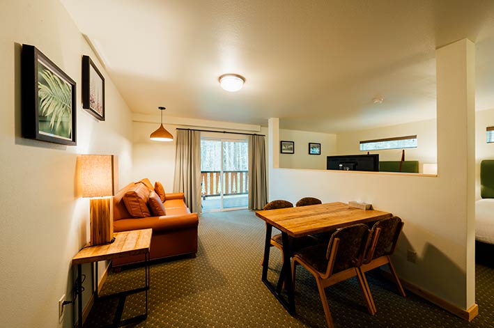 A lounge and dining area in a hotel suite.