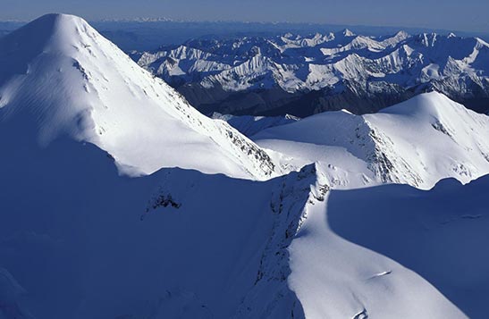 A view high above snow-covered mountains.