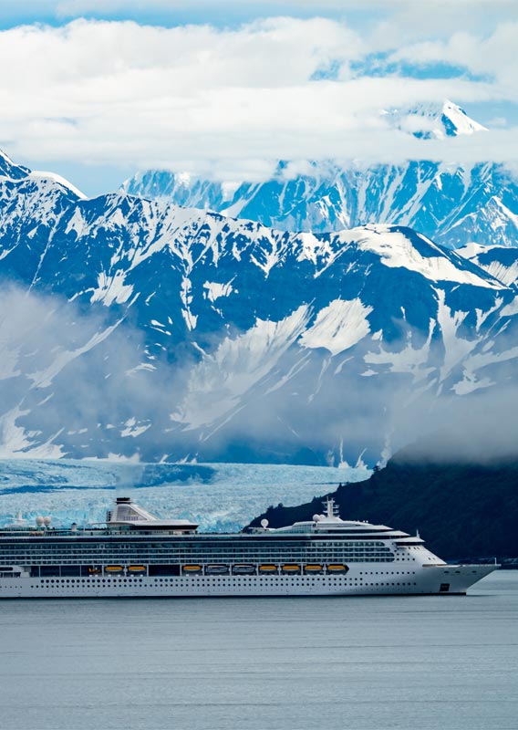 Cruise ship sailing beside a glacier