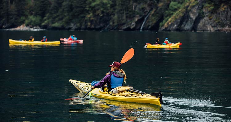 A lady, pictured in the foreground, kayaking with several others