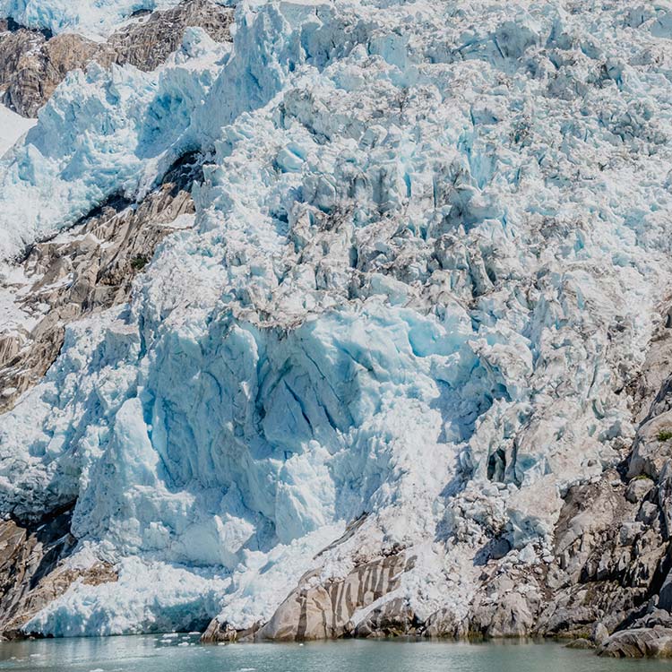 A massive tidewater glacier meets the sea.