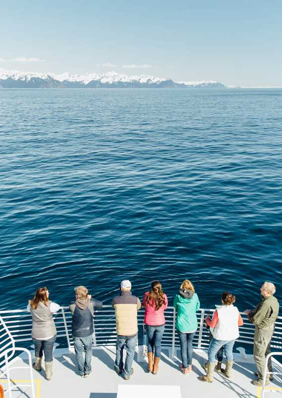 Group of people looking at scenery from the boat deck